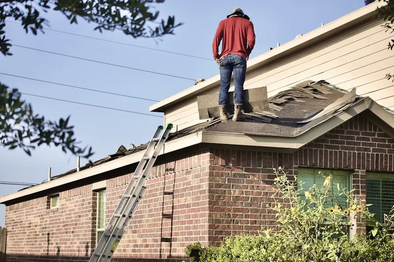 Professional roofer working on a residential roof in Burkettsville